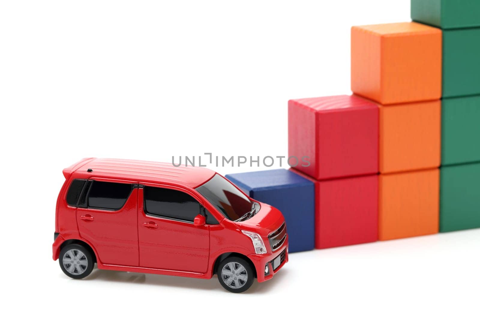 Small toy car and wooden colorful building blocks on white background