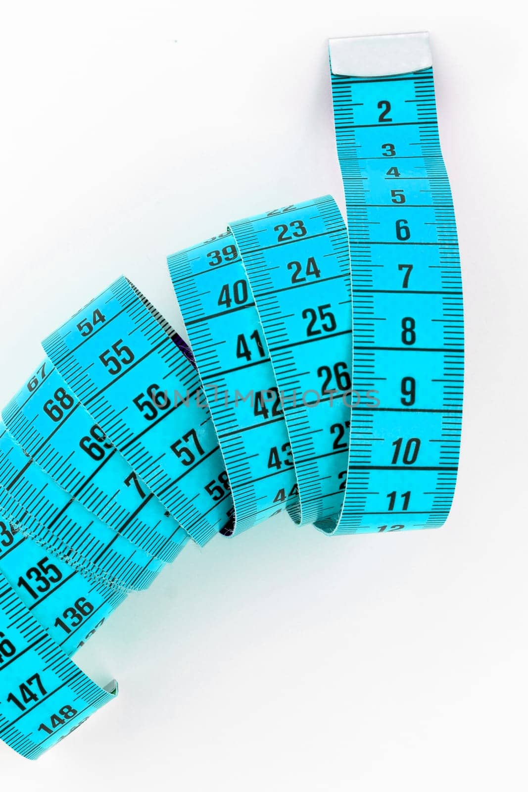 Top view of a blue tailor meter, isolated on white background.