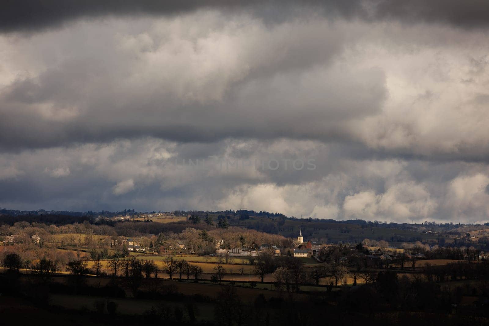 Panorama of landscape with town and clouds