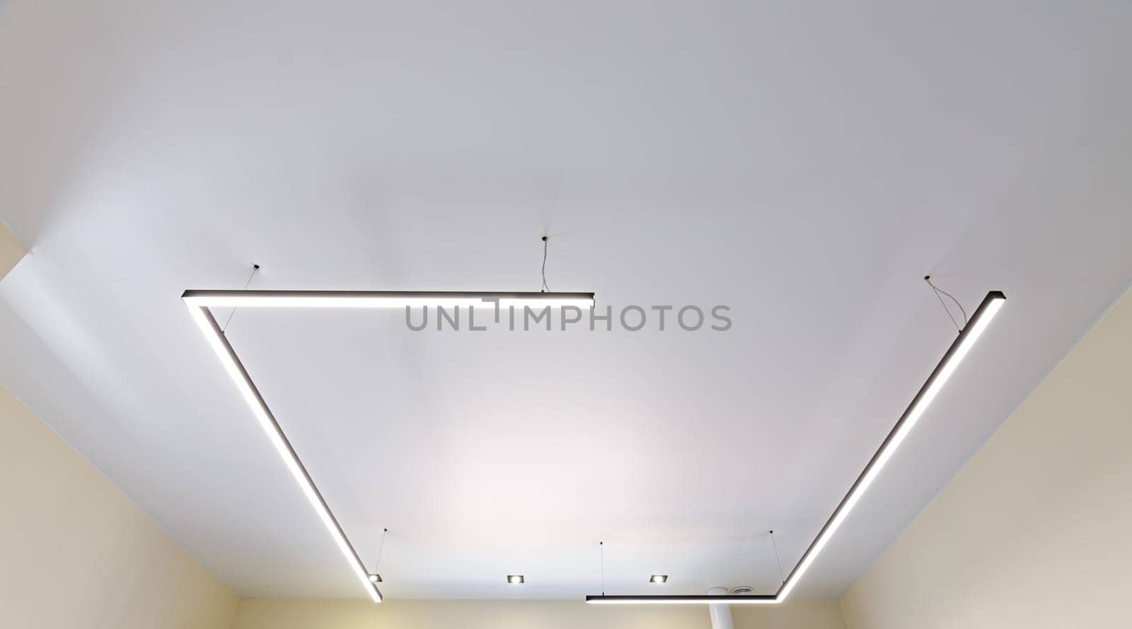 Modern white matte stretch ceiling with original fixtures