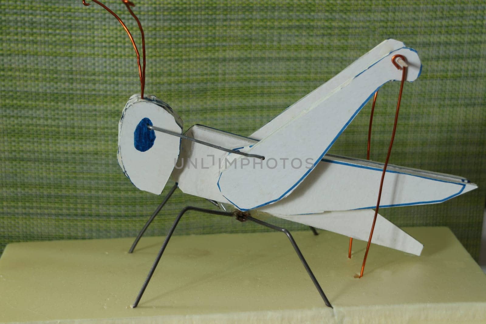 grasshopper homemade mechanical toy close-up