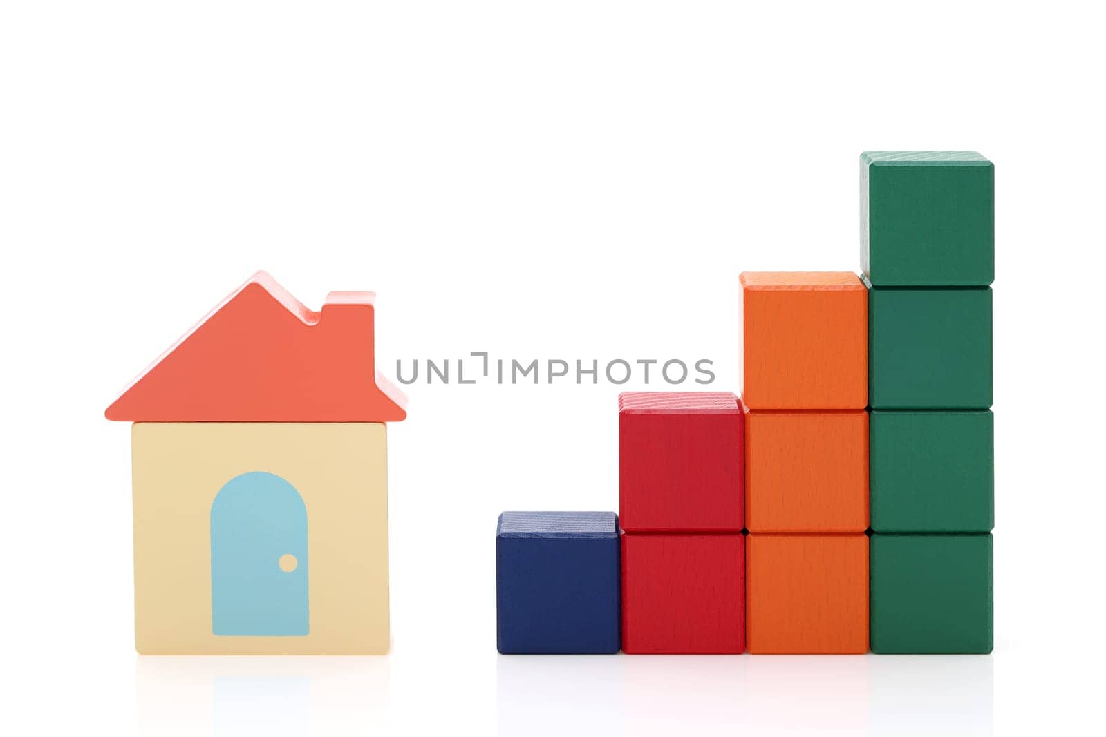 small toy house and wooden colorful building blocks on white background