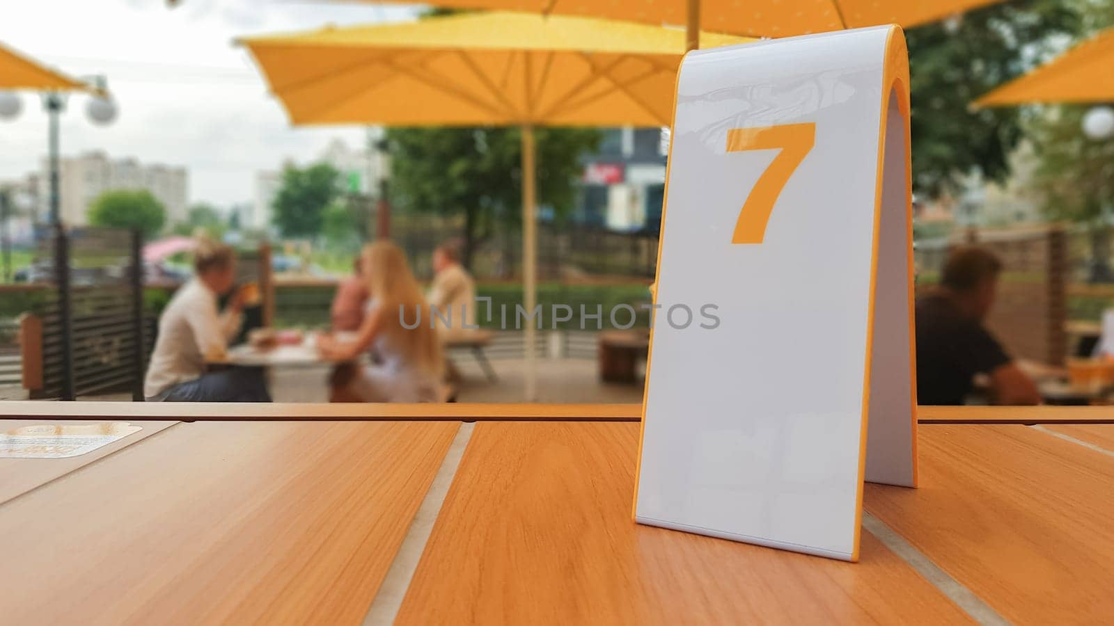 the order number on the table on the street in a McDonald's restaurant. Awaiting an order at a McDonald's restaurant. Fast food with invoice, check. Ukraine, Kiev - September 6, 2019