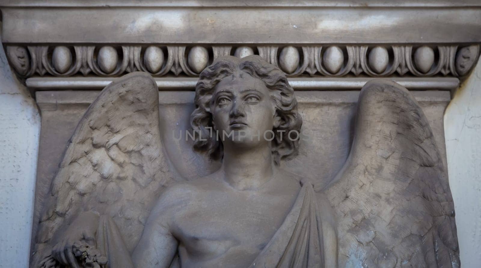 GENOA, ITALY - June 2020: antique statue of angel (beginning 1900, marble) in a Christian Catholic cemetery - Italy