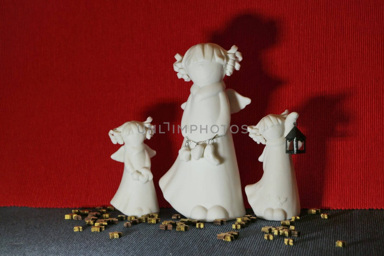 white angels three small figurines in female form angel day concept, still life