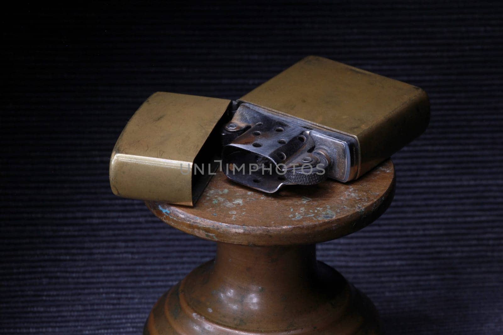 brass petrol lighter on a dark close-up, still life