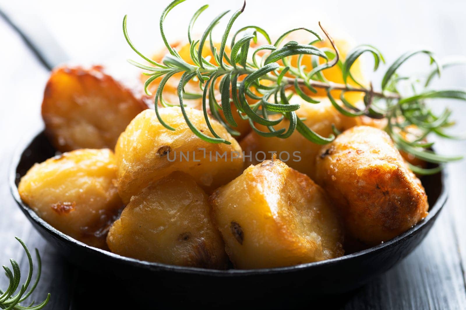close up of  pan of rustic golden english roasted duck fat potatoes