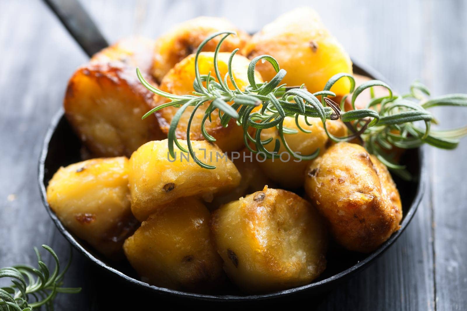 close up of  pan of rustic golden english roasted duck fat potatoes