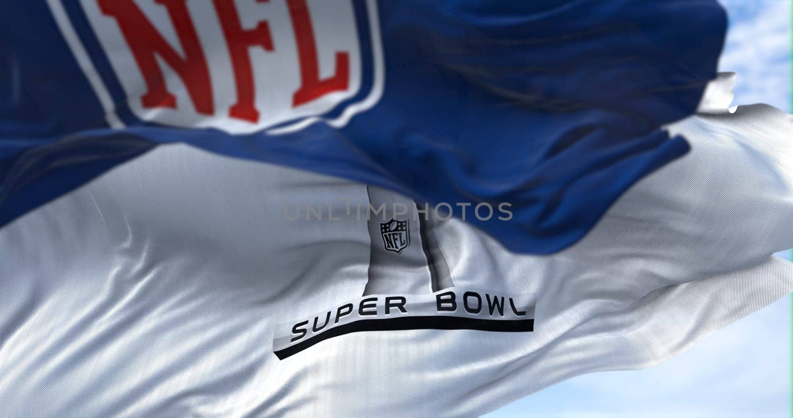 Inglewood, CA, USA, January 2022: The flag with the Super Bowl logo waving in the wind with the NFL flag blurred in the foreground. The game is scheduled to take place on February 13, 2022