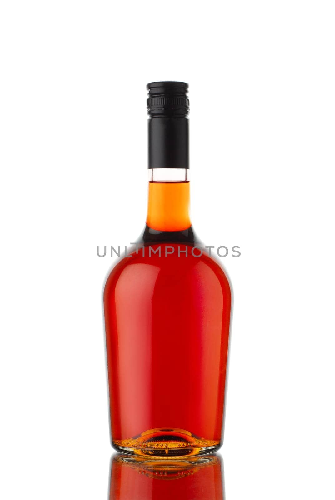 front view closeup of round traditional shape cognac brandy or whisky bottle with no label isolated on white background with reflection