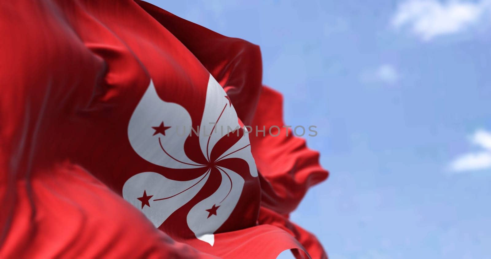 Detail of the civil flag of Hong Kong waving in the wind on a clear day. Selective focus. Hong Kong is a city and special administrative region of China