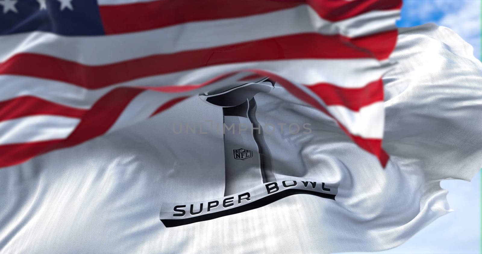 Inglewood, CA, USA, January 2022: The flag of the Super Bowl waving in the wind with the US national flag blurred in the foreground. The Super Bowl is the annual playoff championship game of the NFL