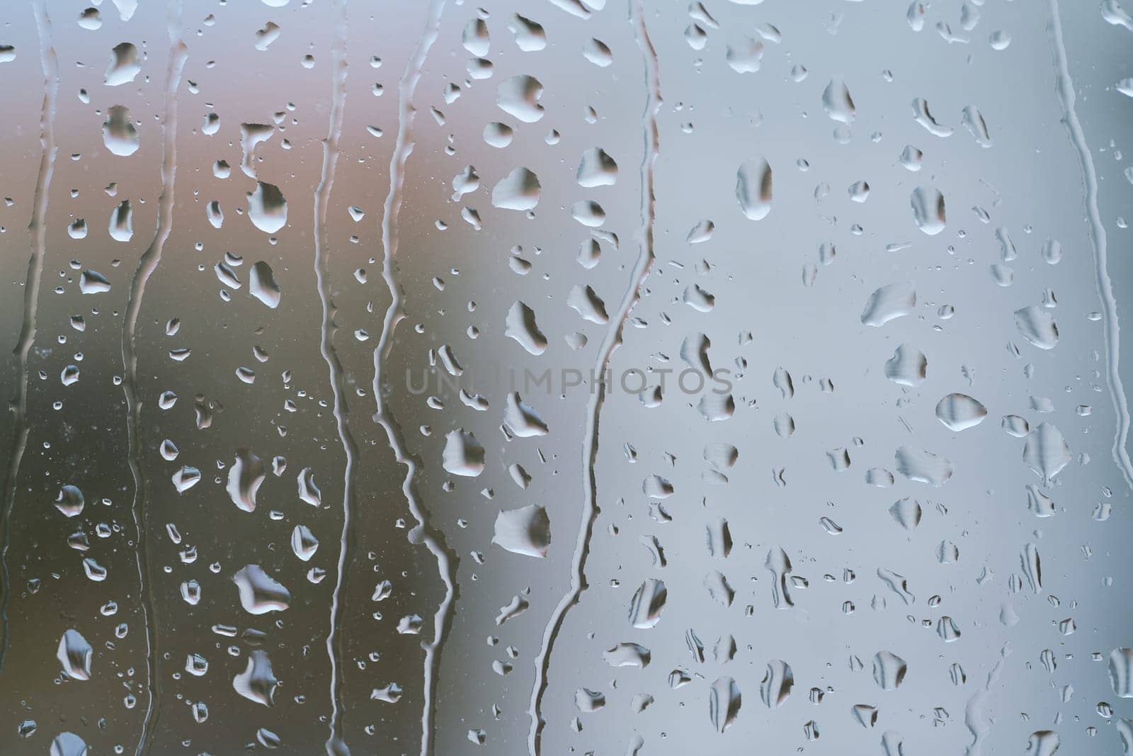 Raindrops on a window pane during rainy weather