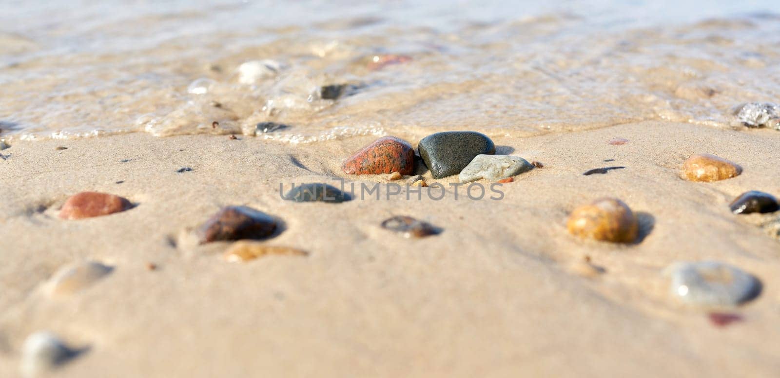Stones on the beach of Kolobrzeg on the Baltic Sea in Poland in summer