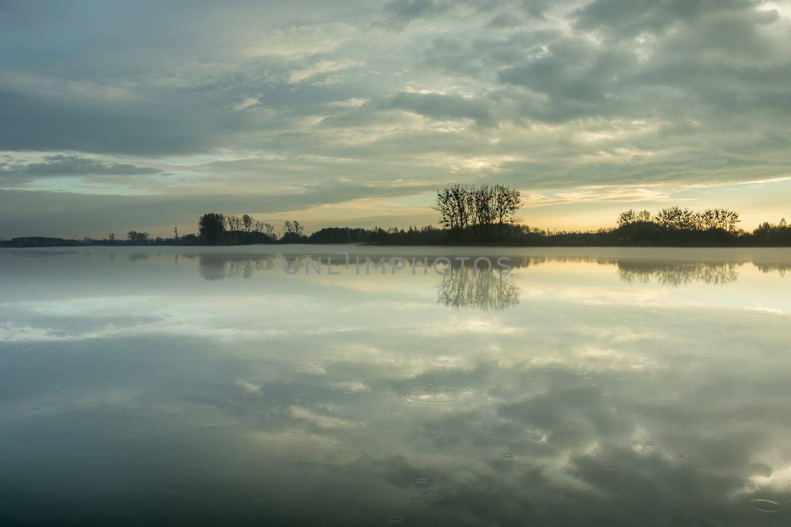 Fog on a calm lake and clouds on the sky, Stankow, Lubelskie, Poland