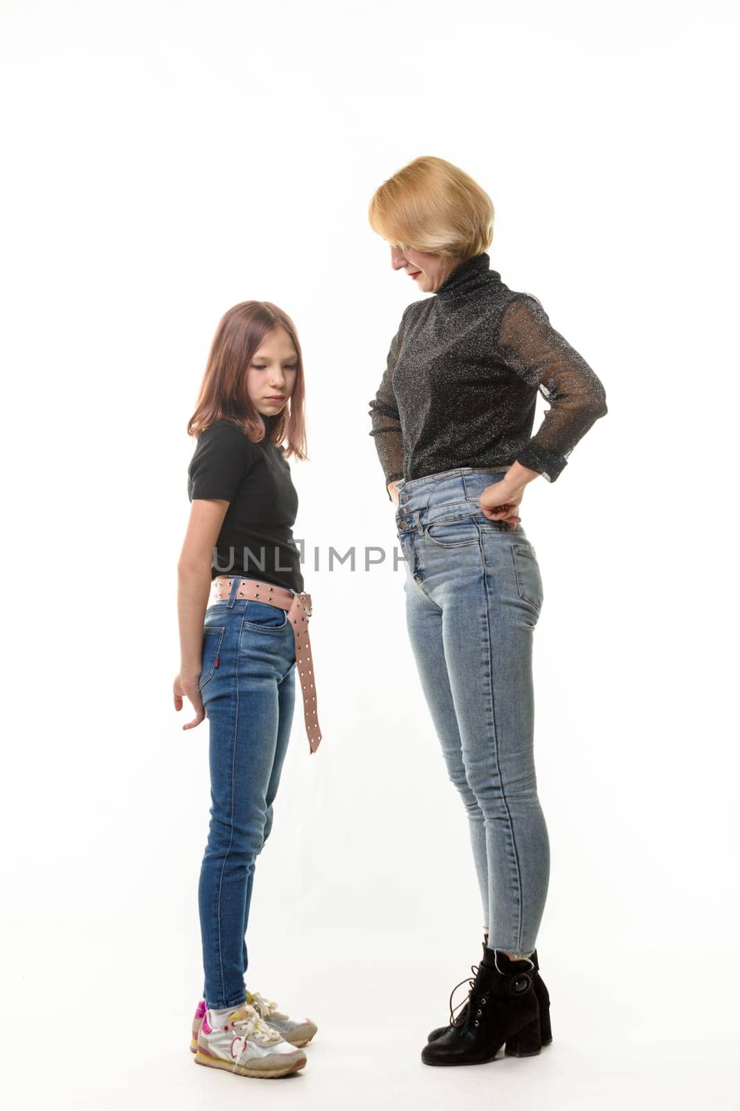 Mother reproachfully looks at the guilty daughter, isolated on white background