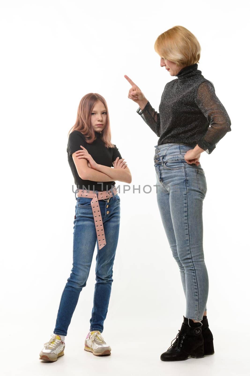 A woman scolds her daughter, an upset daughter looks into the frame