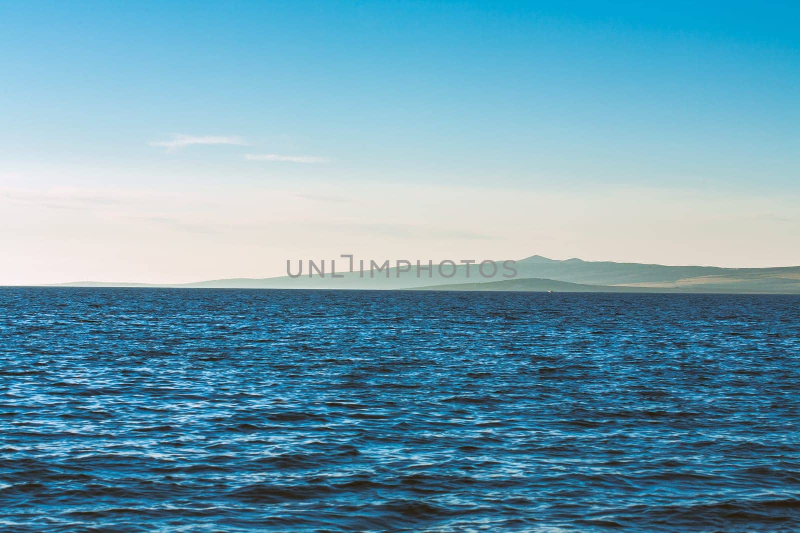 Beautiful coast, blue sea and mountains in the distance. Nice view of the blue Adriatic sea during a sunny day.