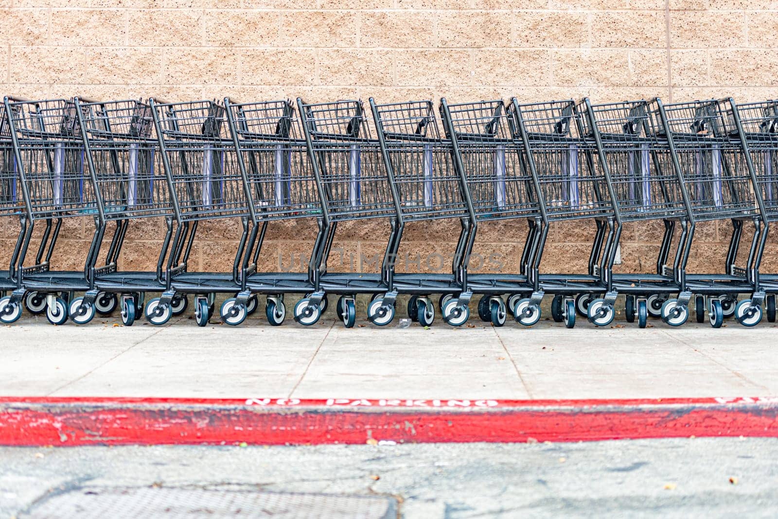 row of empty shopping carts in the big supermarket in California, USA