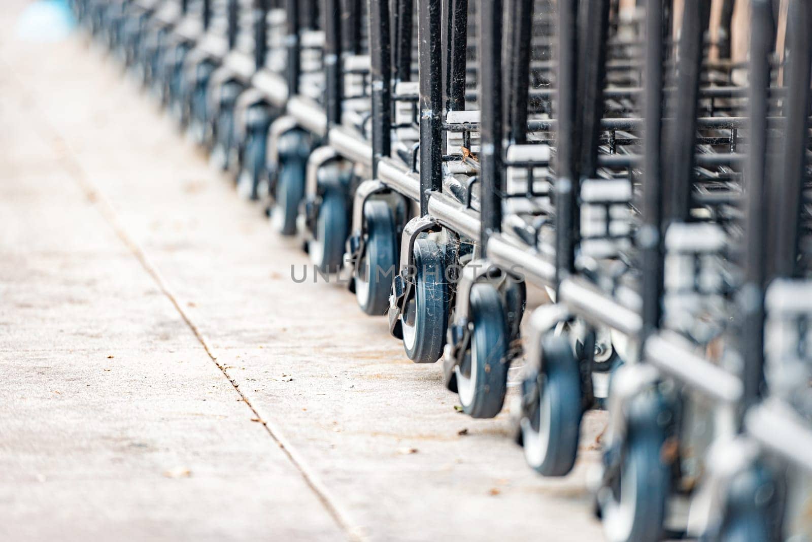 row of empty shopping carts in the big supermarket in California, USA