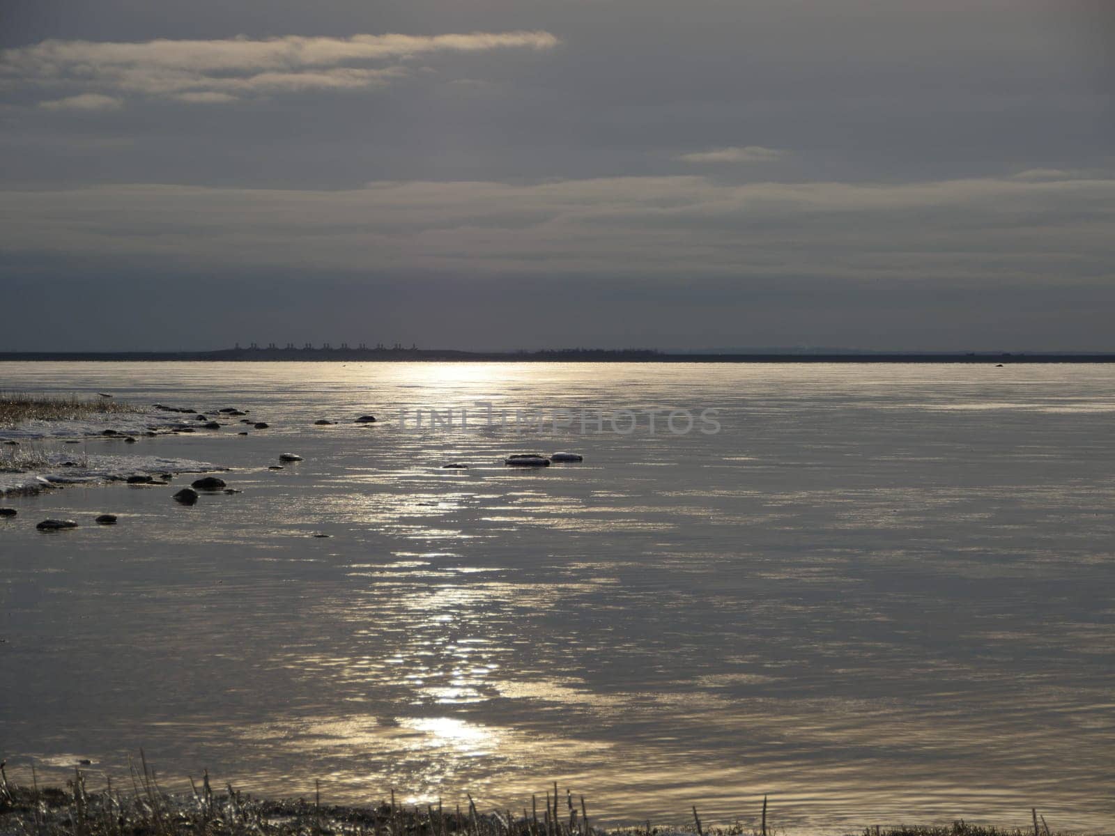 dark cloudscape dramatic seascape, water covered with ice