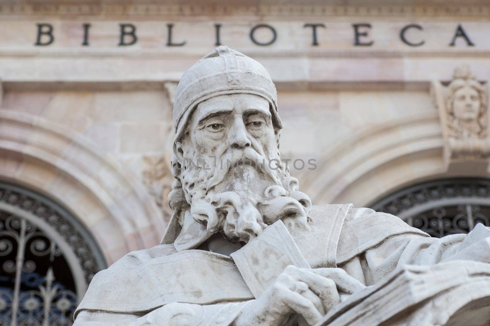 Madrid, Spain - March 6th, 2021: Isidore of Seville statue at National Library of Spain, Madrid. Medieval Spanish scholar