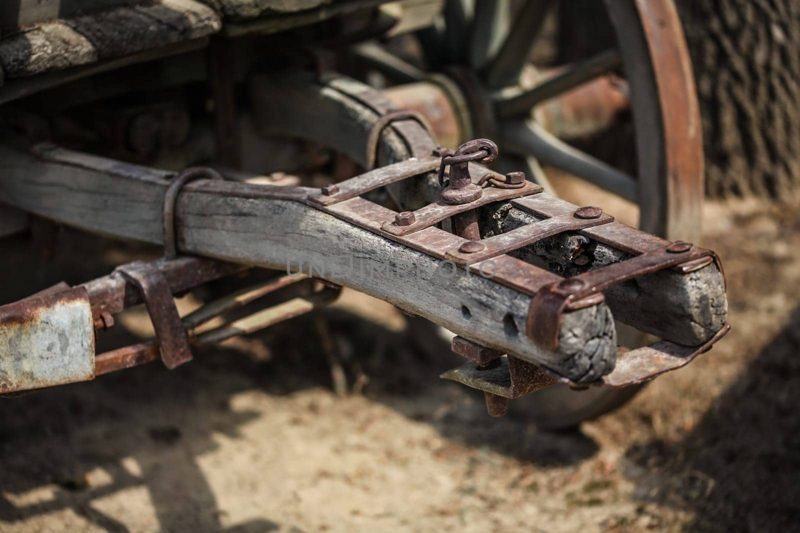 Detail on old rusty wooden wagon connecting mechanism.