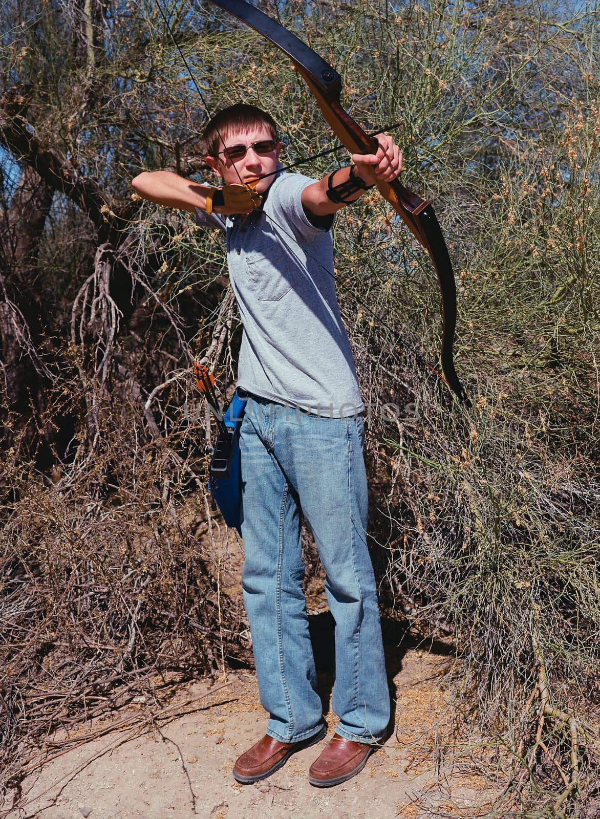 Young archer shooting a traditional long bow