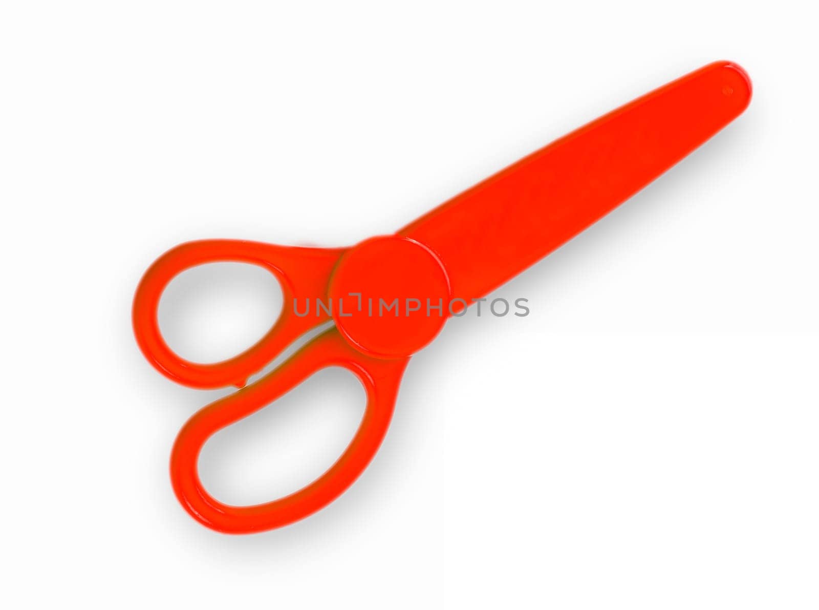 The red baby scissors cut out on a white background. View from above