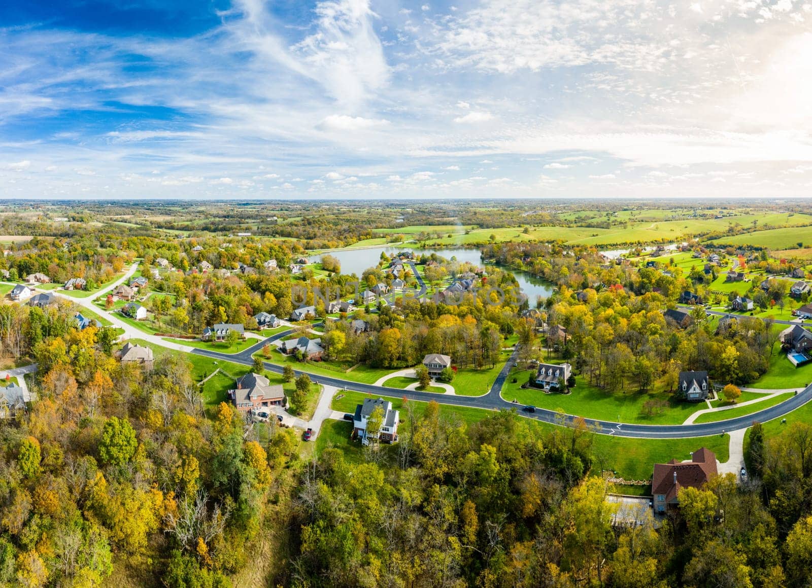 Aerial footage of residential subdivision by a lake in Central Kentucky in fall