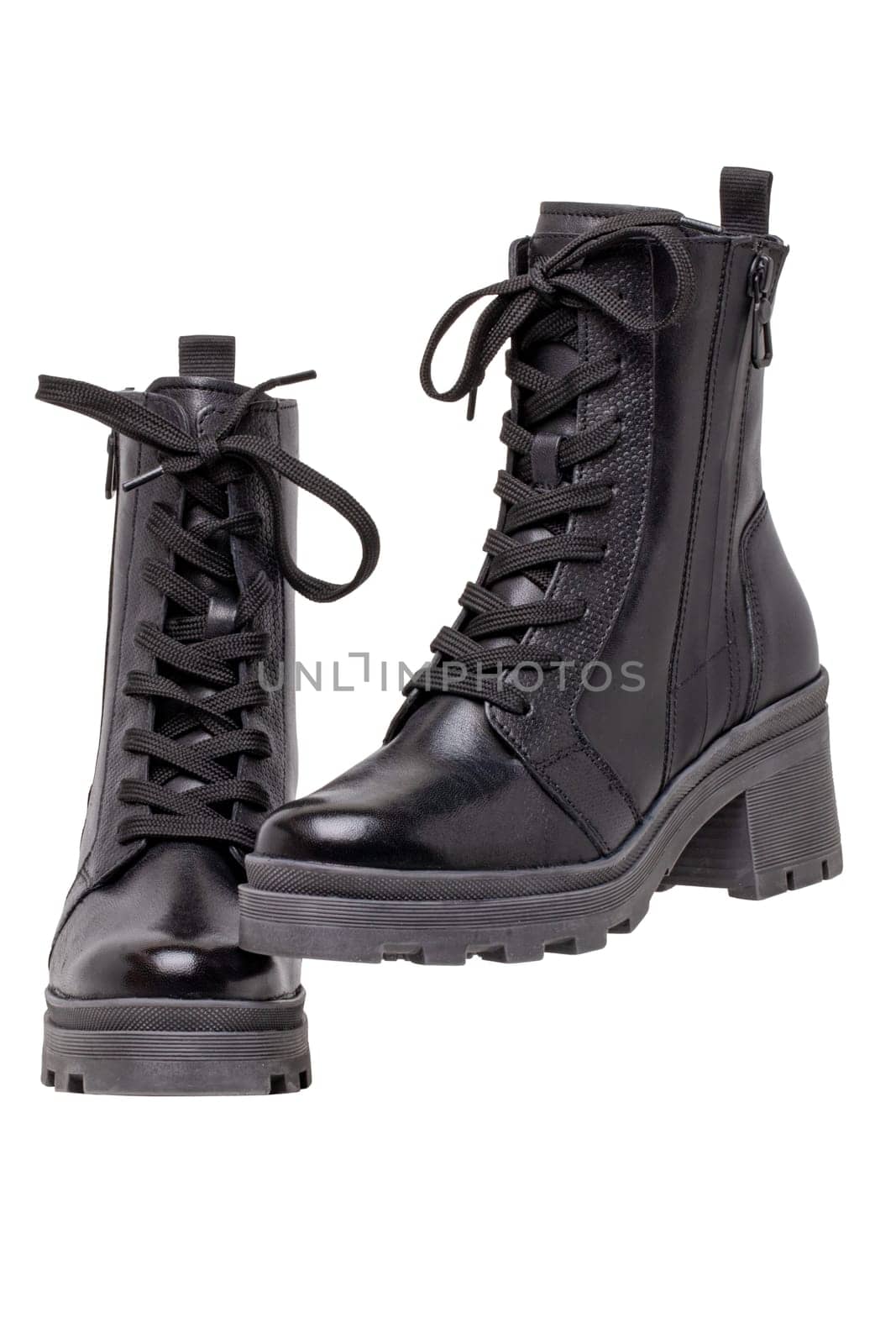 Womens boots and shoes. Closeup of a pair female elegant black leather winter boots. Winter shoe fashion for girls isolated. Clipping path. Macro.