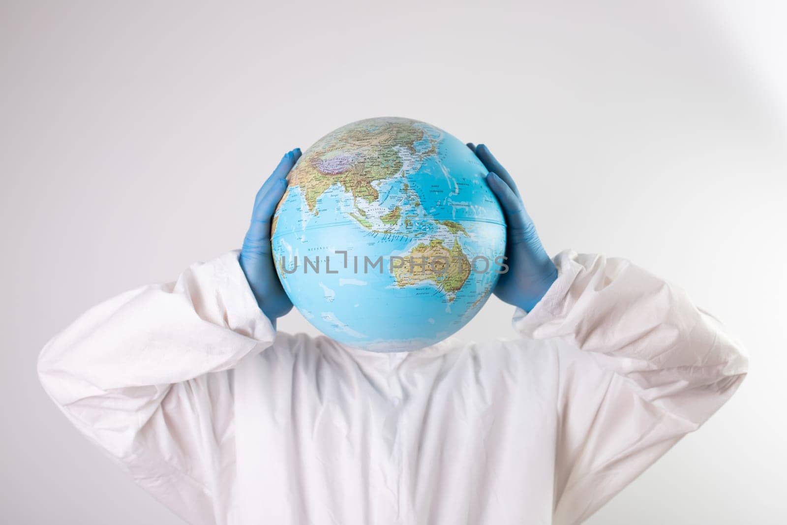 World epidemic danger concept.Male doctor with earth globe and top hat instead of head.