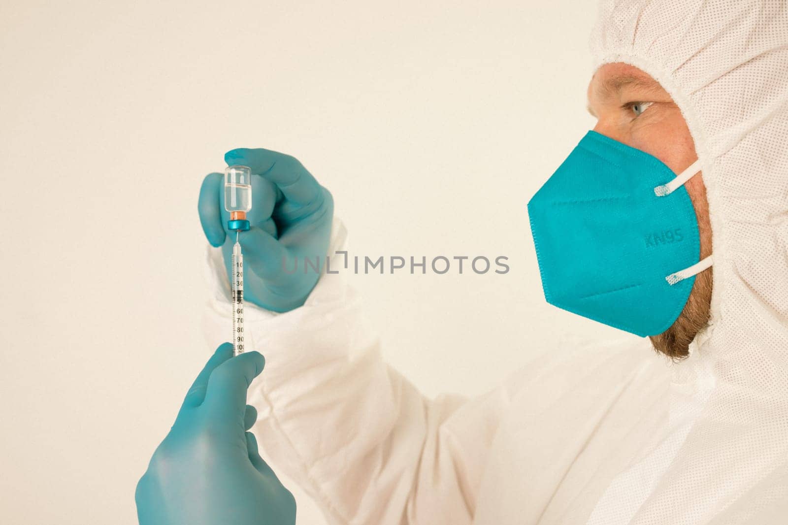 COVID-19 coronavirus vaccine. Vaccination concept. Doctor's hand in blue gloves hold medicine vaccine vial bottle and syringe.