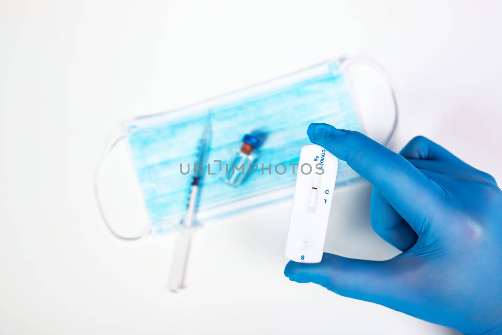 Flat lay of vaccine, test and medical mask. The concept of prevention during Coronavirus pandemic.