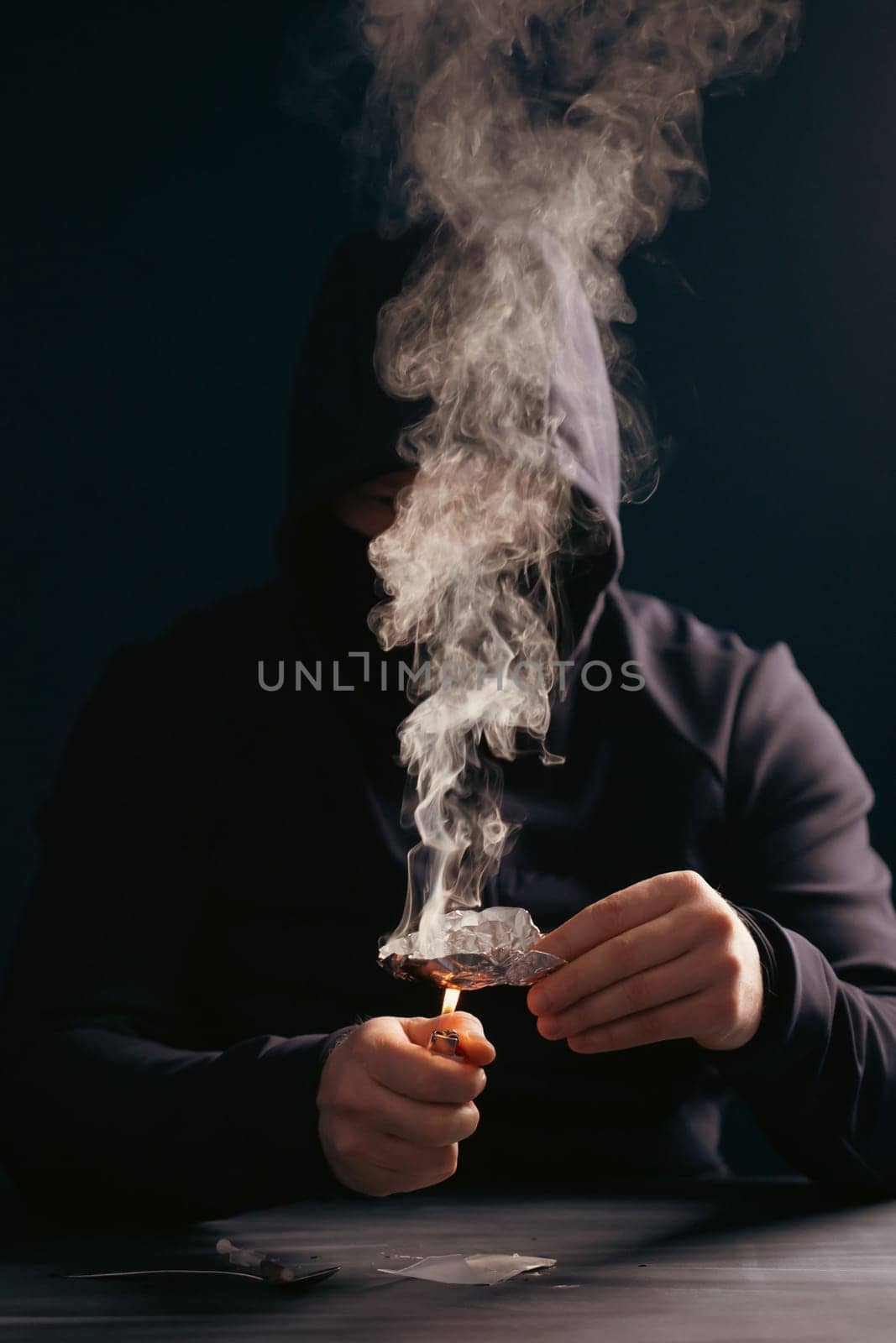 Addict/junkie man preparing drugs. The concept of crime and drug addiction.