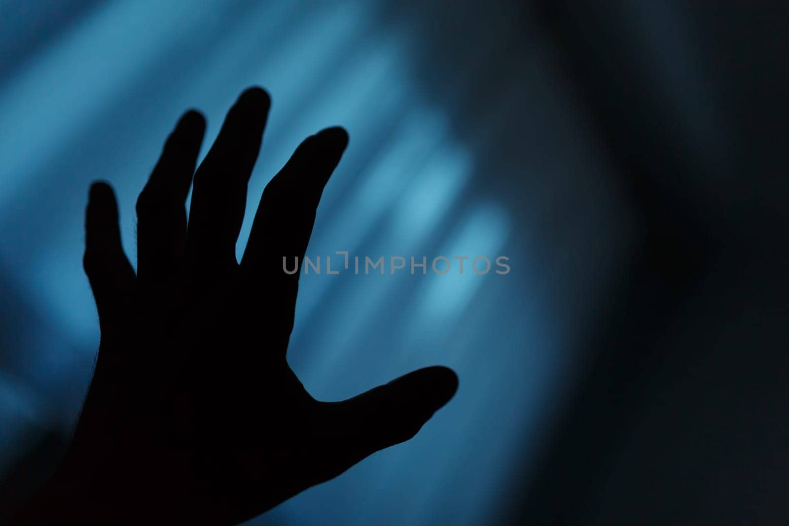 Dark hand shadow reaching into the unknown