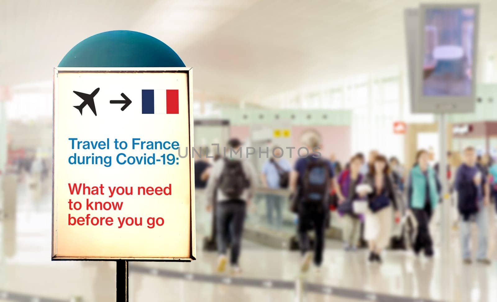 a signal inside an airport that warns about what to know before flying to France during the Covid-19 pandemic. Airport security measures and travel restrictions. New Covid-19 variant spread