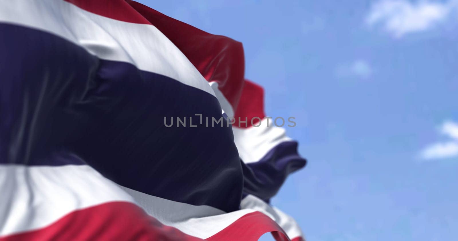 Detail of the national flag of Thailand waving in the wind on a clear day. Democracy and politics. Patriotism. Selective focus. South east Asian country.