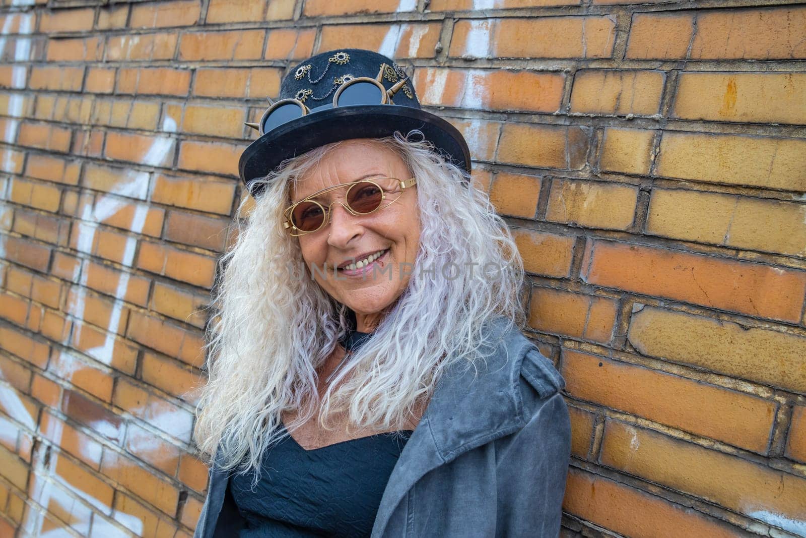 Beautiful Steam Punk Lady standing on a Brick Wall Background