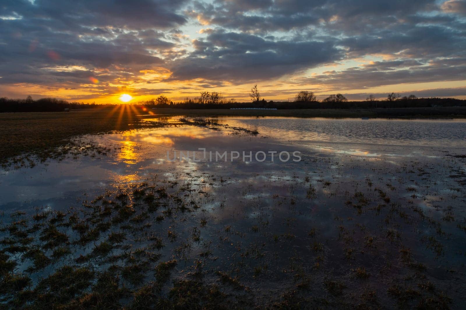 Flooded meadow after downpour, clouds and sunset, Nowiny, Poland