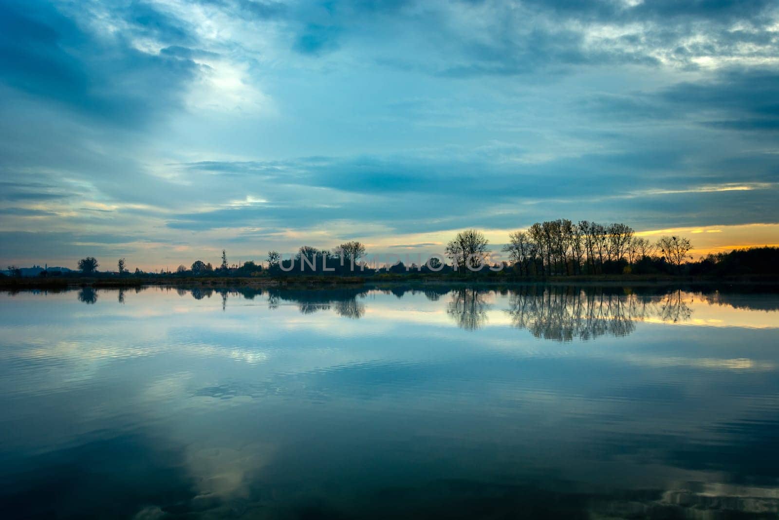 Evening blue clouds over a calm lake, Stankow, Lubelskie, Poland