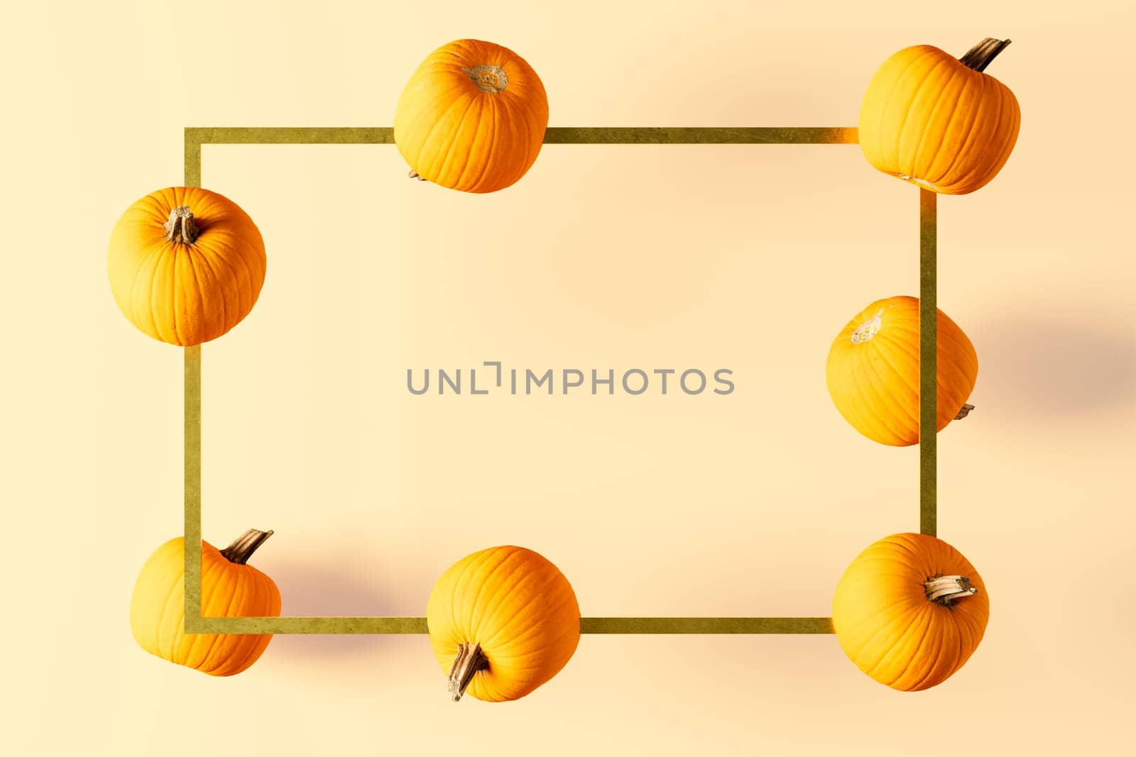 3D rendering of flying pumpkins around a golden rectangle frame. Usable for product or text promotion or showcase