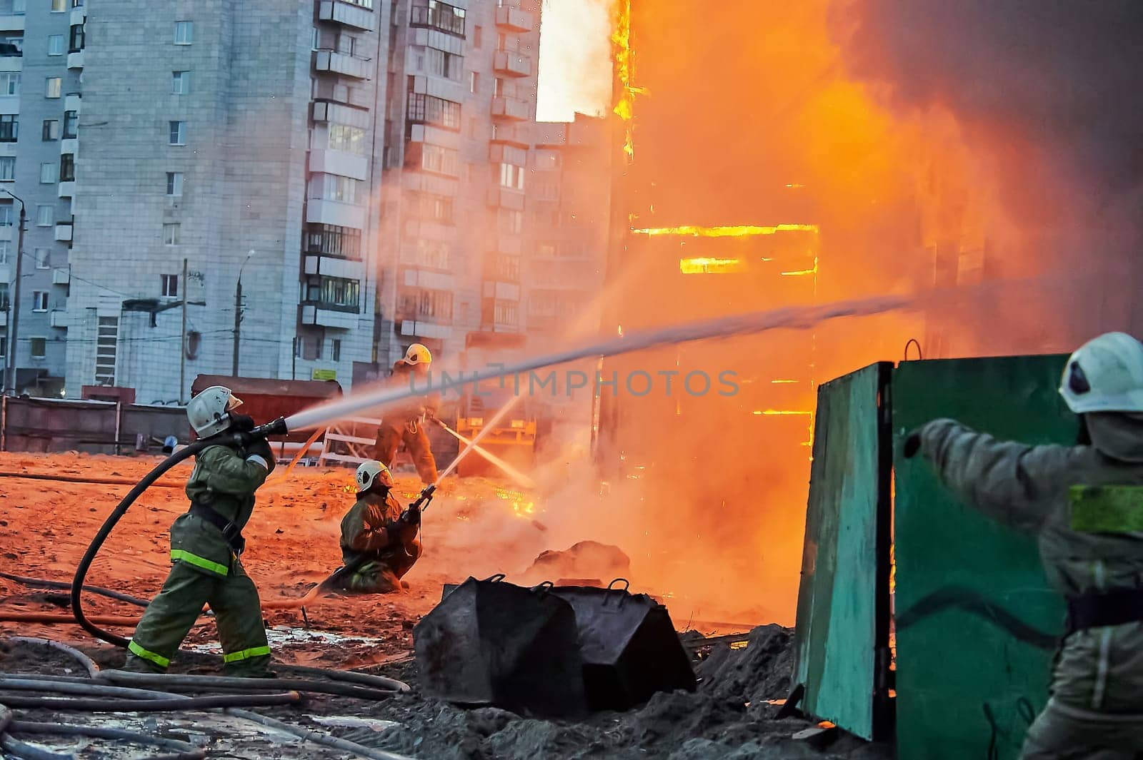 Firefighters extinguish a fire in a two-story wooden house. High quality photo