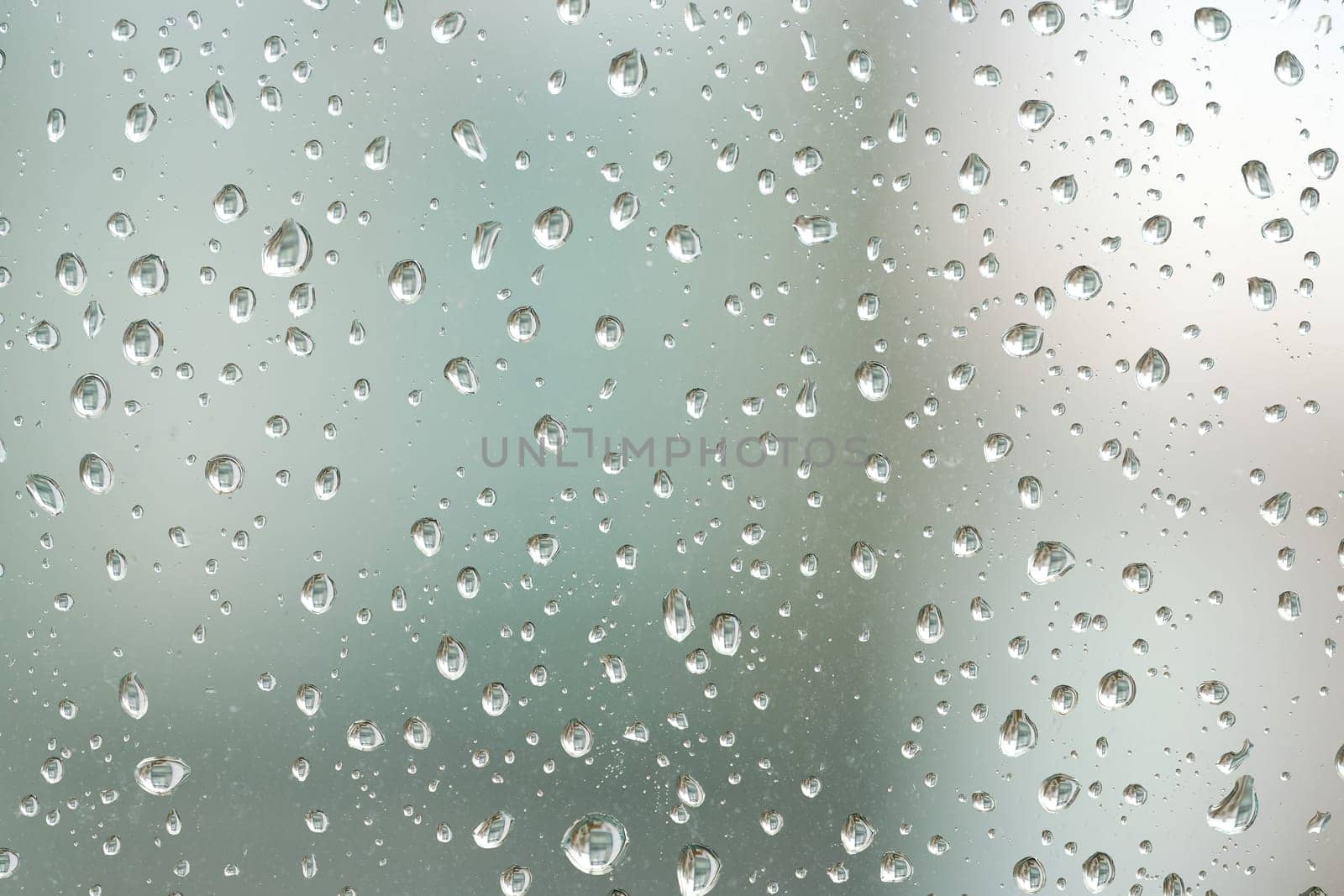 Raindrops on a window pane during rainy weather
