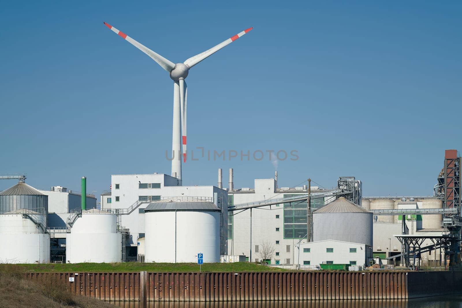 Industrial plant and wind turbine in the Port Kanalhafen of Magdeburg on the river Elbe