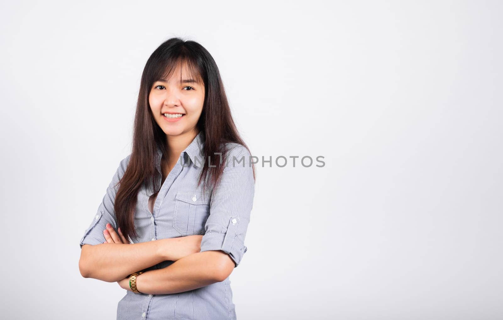 Woman standing her smile confidence with crossed arms isolated white background, Asian happy portrait beautiful young Thai female looking to camera in studio shot on white background and copy space