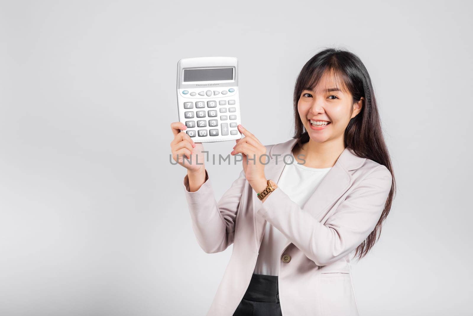 Tax day concept. Woman confident smiling holding electronic calculator, Portrait excited happy Asian young female studio shot isolated on white background, Business Account and finance counting income