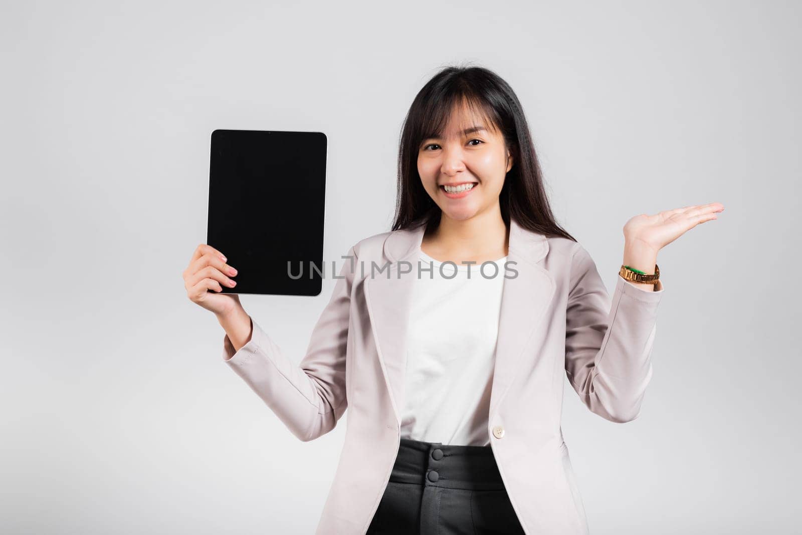 Asian beautiful young woman smiling using tablet computer, Happy female show blank screen digital tablet pc and presenting product with palm of hand at empty, studio shot isolated on white background