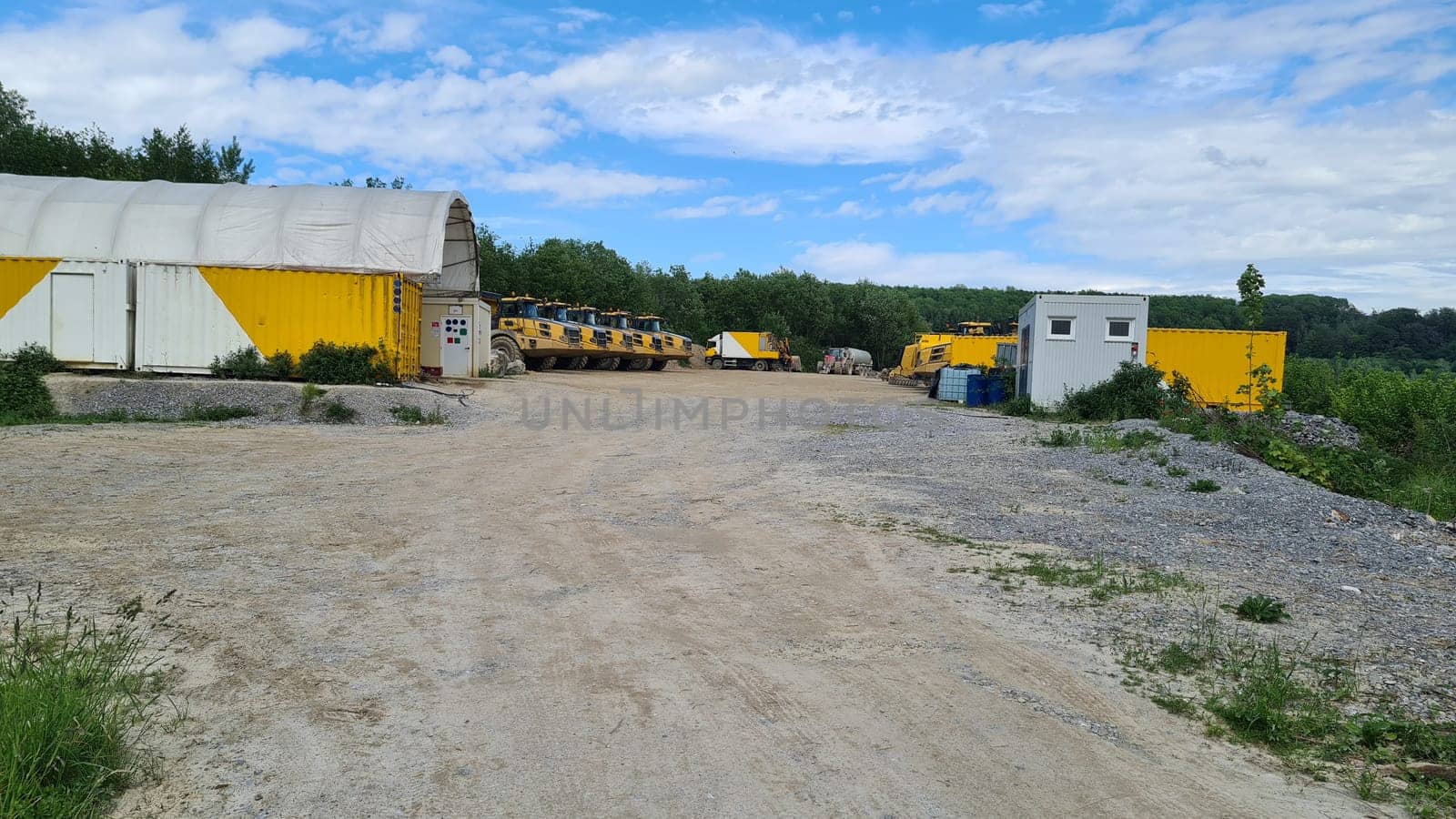 A large quarry dump truck in a coal mine. Loading coal into body trucks. Mining equipment for the transportation of minerals.