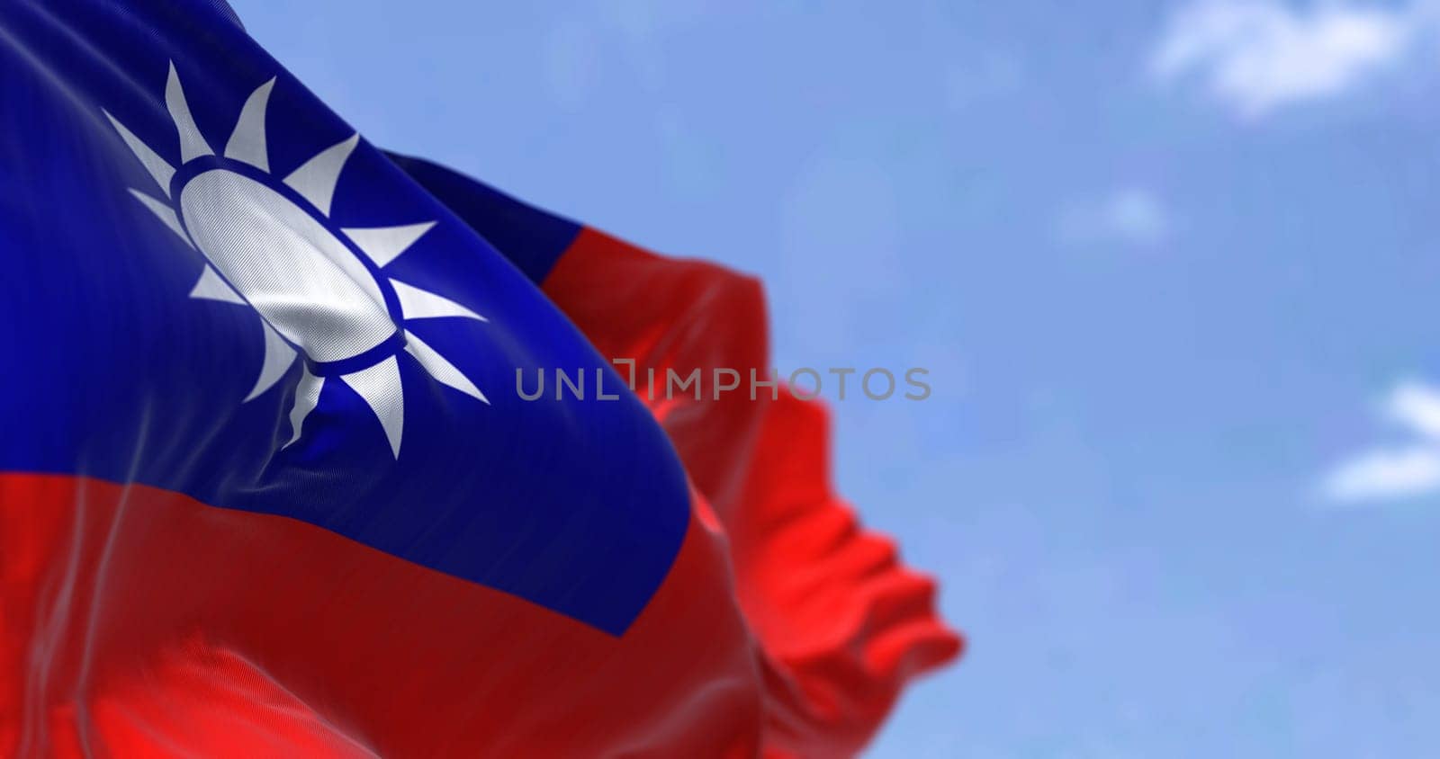 Detail of the national flag of Taiwan - Republic of China waving in the wind on a clear day. Democracy and politics. Patriotism. East asian country. Selective focus.